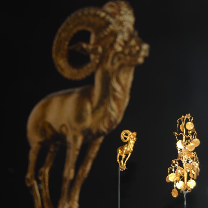 Image of a gold standing ram and a gold and pearl headdress shaped like a tree